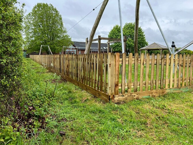 a new picket fence around a playground in Oxfordshire